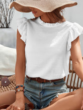 Top sin mangas de color liso con lazo y volantes